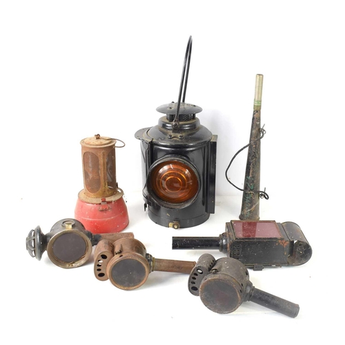 150 - A group of vintage lamps and lanterns to include an Adlake Non-Sweating railway lamp.