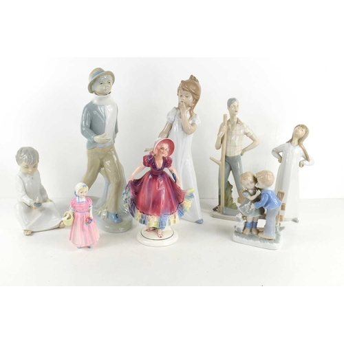 197 - A group of porcelain figures to include Lladro Nao, Royal Doulton, Dipa and others.