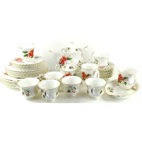 203 - A Royal Albert part tea and dinner service in the Poinsettia pattern, comprising eight dinner, side ... 