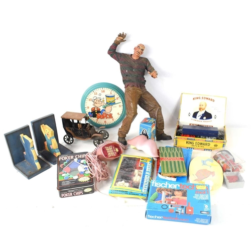 22 - A group of vintage toys to include a Popeye 1984 clock, Porky Pig soap in the original box, Bratz ph... 