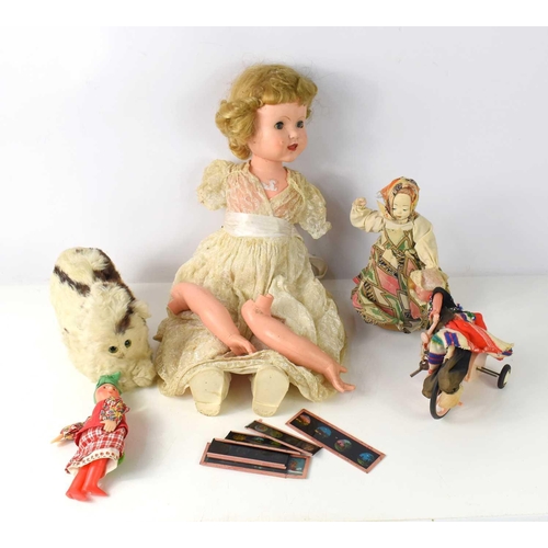 27 - A vintage doll together with a cuddly toy with rabbit fur, a wind up moving doll and other items.