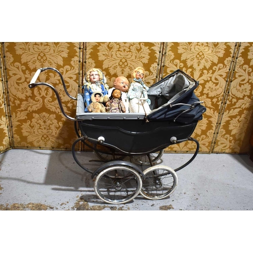 41 - A vintage Marmet coach built dolls pram together with a group of dolls.