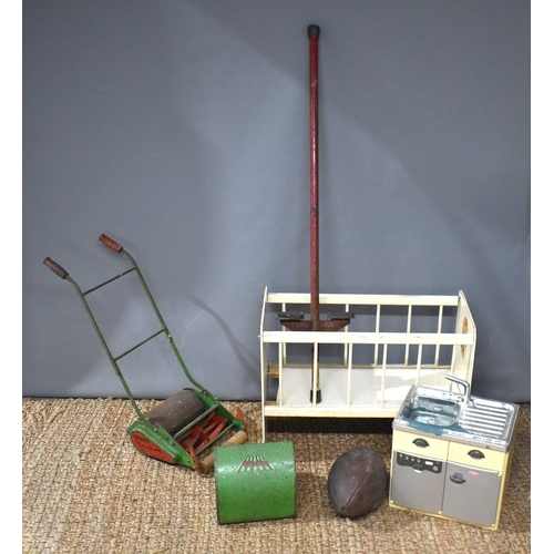 45 - A vintage Webb children's lawnmower together with a wooden dolls cot, a Kelo Pogo stick, childrens p... 