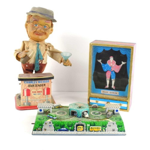 52 - A group of vintage toys to include a battery operated Charlie Weaver Bartender, wind up Magic Dancer... 