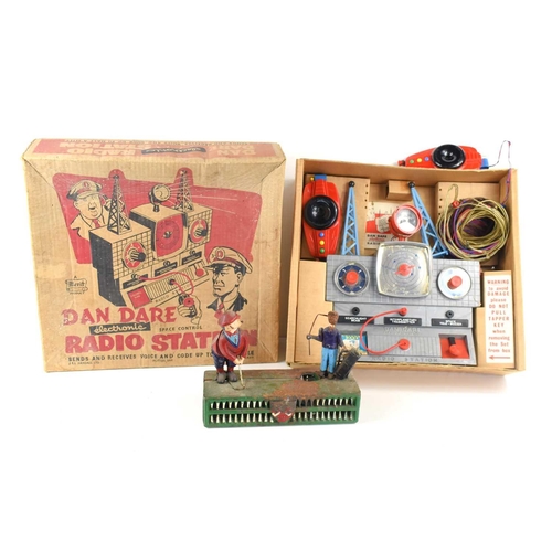 56 - A vintage Dan Dare radio station in the original box together with a cast iron golfing coin bank.