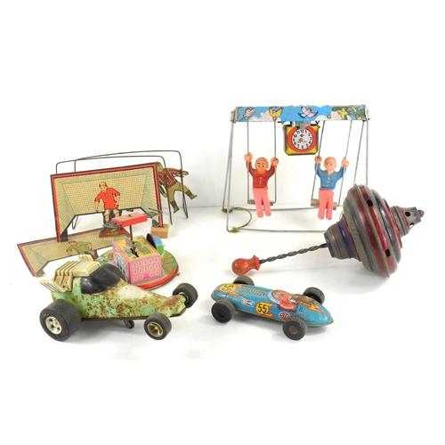 58 - A group of vintage toys to include a tin plate wind up swing, wind up fairground ride, spinning top,... 