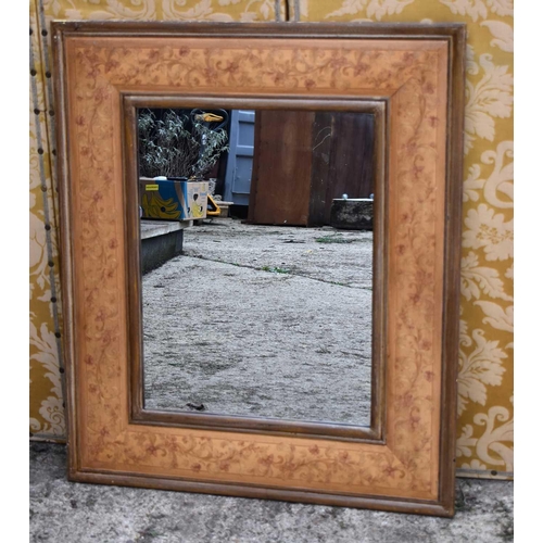 584 - A 20th century wall mirror with painted floral border, 87cm by 102cm.