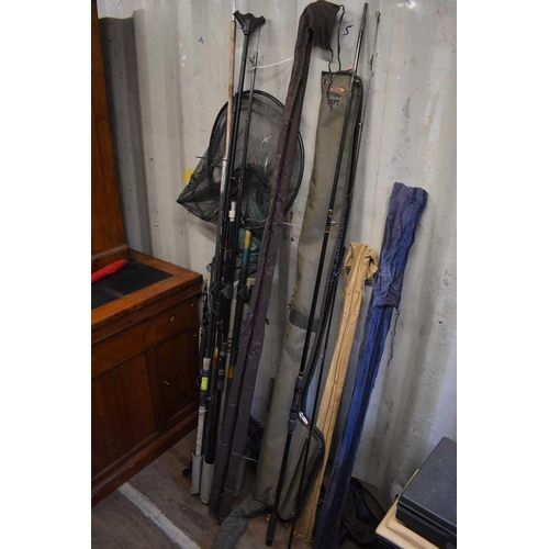 590 - A group of fishing rods, rod holdalls, nets, whips and umbrellas, examples to include Daiwa 