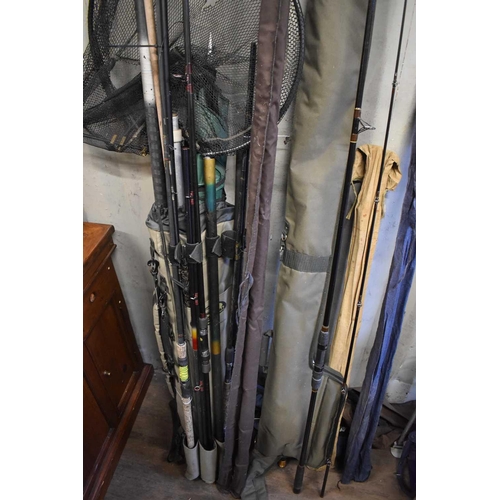 590 - A group of fishing rods, rod holdalls, nets, whips and umbrellas, examples to include Daiwa 