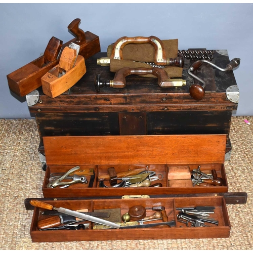 602 - A carpenters tool chest with a quantity of antique tools to include drill bits and brace, spirit lev... 