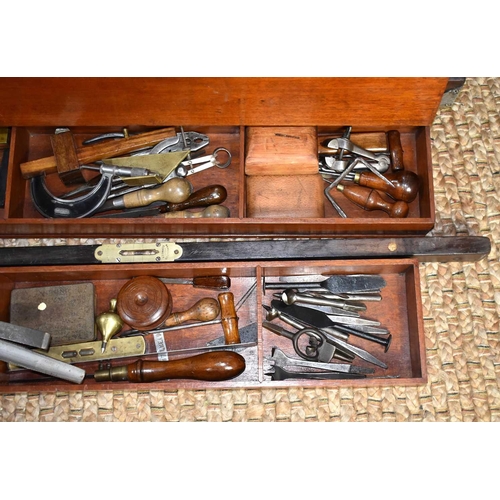 602 - A carpenters tool chest with a quantity of antique tools to include drill bits and brace, spirit lev... 