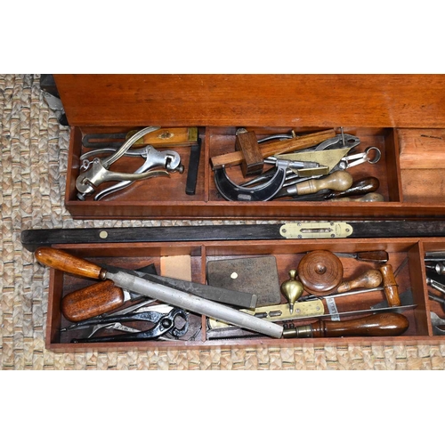 602 - A carpenters tool chest with a quantity of antique tools to include drill bits and brace, spirit lev... 