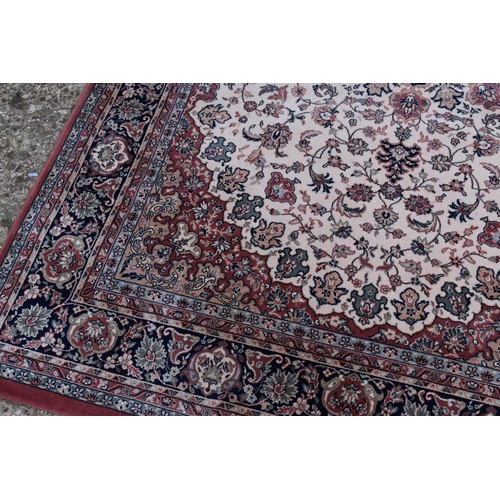 606 - A Royal Classic rug made from New Zealand wool, red ground with floral decoration, 170cm by 246cm, t... 