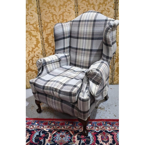 649 - A 20th century wingback armchair, in tweed upholstery., 120cm high.