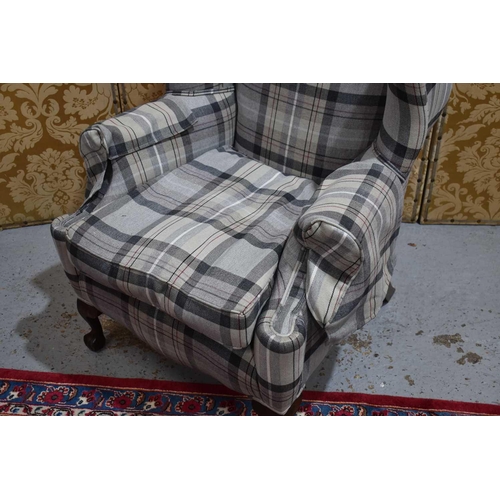 649 - A 20th century wingback armchair, in tweed upholstery., 120cm high.