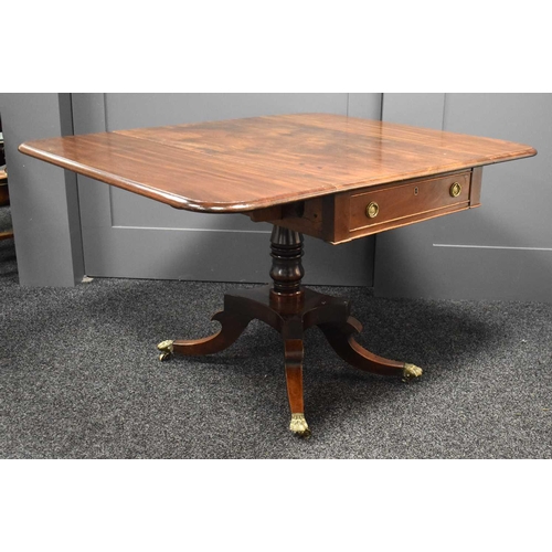 650 - A Regency mahogany Pembroke table, raised on four fluted uprights on a quadripartite base which feat... 