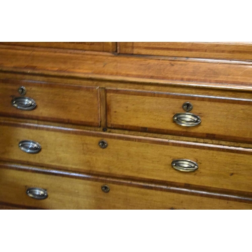 658 - A Georgian oak cabinet on chest, the upper portion with moulded cornice over a pair of panelled door... 