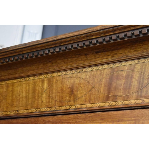 658 - A Georgian oak cabinet on chest, the upper portion with moulded cornice over a pair of panelled door... 