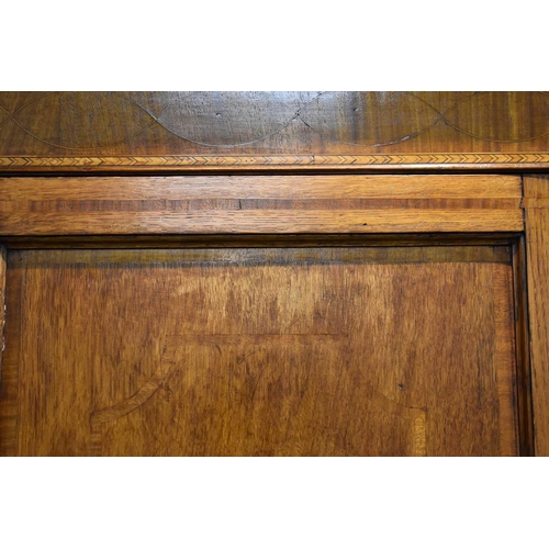 658 - A Georgian oak cabinet on chest, the upper portion with moulded cornice over a pair of panelled door... 