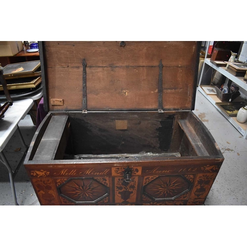 664 - An 18th century oak domed topped chest of large proportions, with later marquetry inlaid decoration,... 