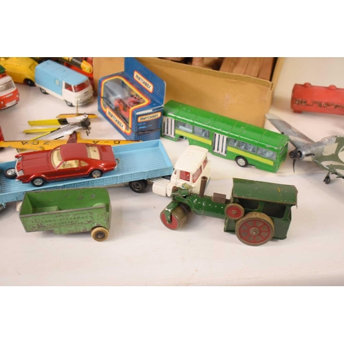 84 - A collection of vintage toy vehicles, including various tin-plate clockwork examples, Britains, Corg... 