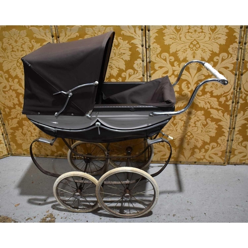 97 - A small silver cross dolls pram.