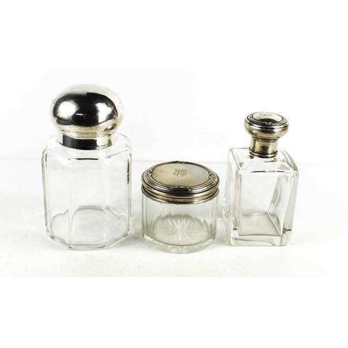 25 - Three antique glass and silver topped dressing table bottles, two of the silver 800 grade tops beari... 