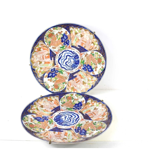 295 - A pair of large Japanese Imari chargers, the 19th century chargers measure 46cm diameter, with secti... 