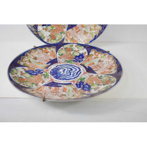 295 - A pair of large Japanese Imari chargers, the 19th century chargers measure 46cm diameter, with secti... 