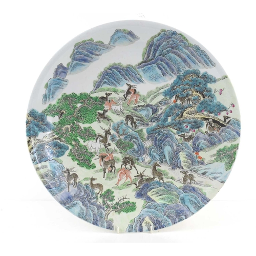 304 - An early 20th century Chinese charger, decorated with deer amongst mountains, with character mark to... 