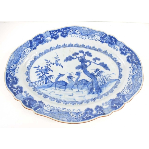 305 - An 18th century Chinese porcelain blue and white plate, of oval shaped form, painted with a pair of ... 