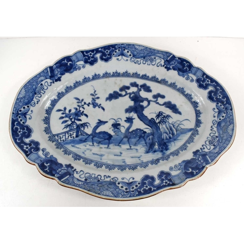 305 - An 18th century Chinese porcelain blue and white plate, of oval shaped form, painted with a pair of ... 