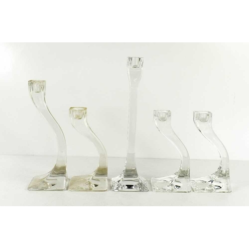 34 - Five Kosta Boda clear glass 'Connect' candlesticks, the tallest measures 25cm high.