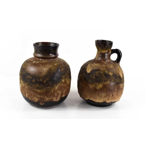 36 - Two West German mid-century pottery vessels, with brown underglaze, the ewer measures 18cm high.