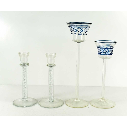 38 - A pair of Kosta Boda spiral stem candlesticks, unsigned, 18cm high, together with a pair of tall ste... 