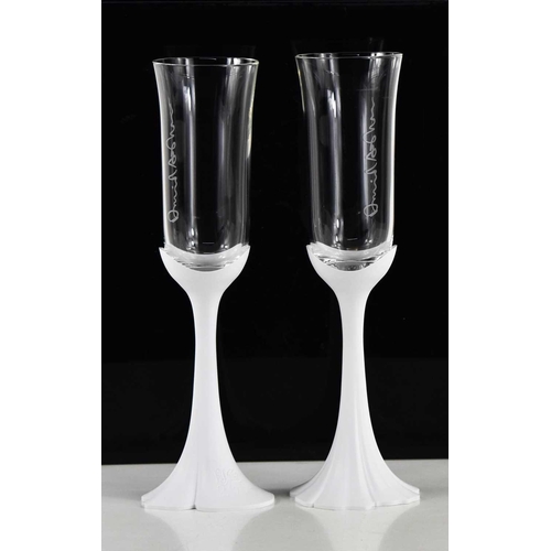 93 - A pair of Oscar de La Renta Champagne flutes, with white perspex stems stamped '200 ans', the glass ... 