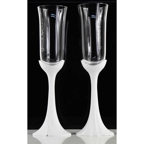 93 - A pair of Oscar de La Renta Champagne flutes, with white perspex stems stamped '200 ans', the glass ... 