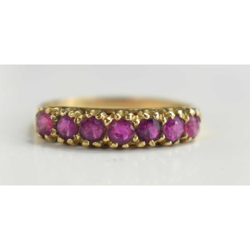 100 - A 9ct gold seven stone ring, set with old cut garnets, size P, 2.1g.
