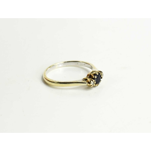 103 - A 9ct gold, sapphire and diamond three stone ring, the central sapphire of approximately 5.1mm adjoi... 