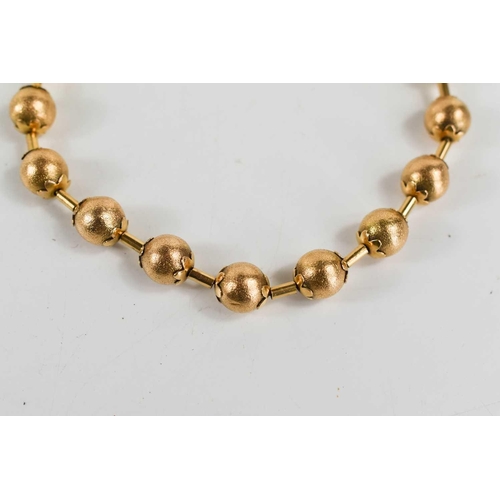 11 - A Victorian gold bracelet of ball and bar form, each ball textured with flower finial to either end,... 