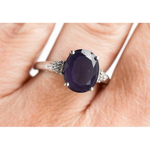 112 - A amethyst and 9ct white gold ring, the shoulders set with diamond brilliants, 3.7g.