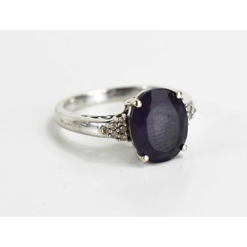 112 - A amethyst and 9ct white gold ring, the shoulders set with diamond brilliants, 3.7g.