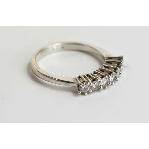 113 - A 9ct white gold and diamond seven stone ring, size N, 2.5g.