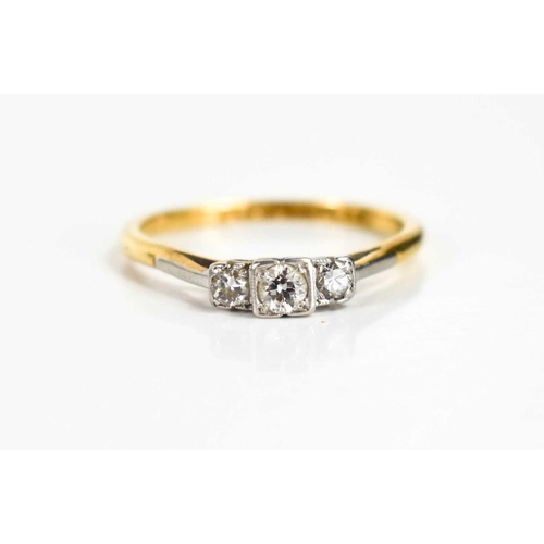 117 - An Art Deco 18ct gold, platinum and diamond three stone ring, the central illusion set stone of appr... 