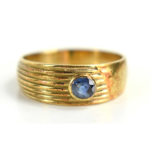 120 - A 14ct gold band set with a sapphire, size T/U, 5.7g.