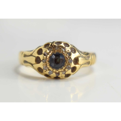 125 - An 18ct gold, sapphire and diamond ring, the central sapphire surrounded by twelve old cut diamond c... 