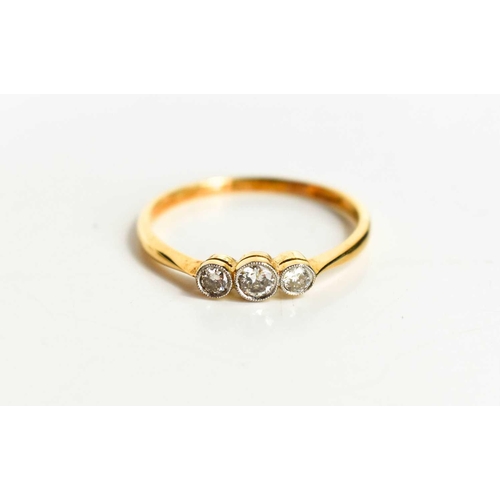 127 - An 18ct gold and diamond three stone ring, the central diamond of approximately 3.2mm diameter, 0.12... 