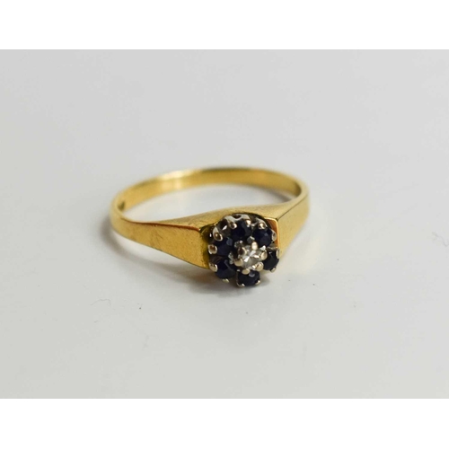 128 - An 18ct gold sapphire and diamond flowerhead ring, the central diamnd of approximately 0.05ct, surro... 