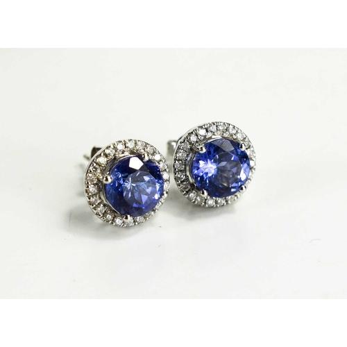 13 - A pair of tanzanite and diamond 18ct white gold earrings, each round cut tanzanite, 4.0g.