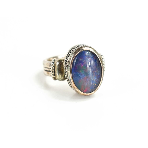 130 - An Indian silver and black opal ring, the opal of approximately 13.5 by 9.5mm, size N.